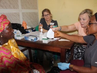Diabetes_Clinic8 Women sitting around table handing paper to other woman
