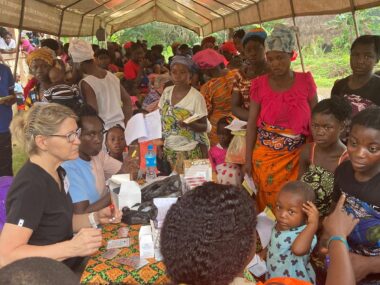PHOTO-2024-07-10-07-43-31 Women and children from the village of Fengehun gathered for care under tent.